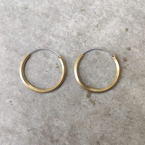 brass hoops on grey background